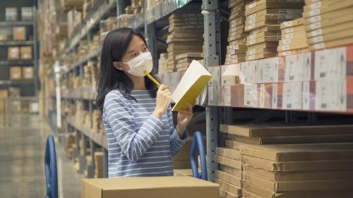 Employee analyzing inventory data in a warehouse